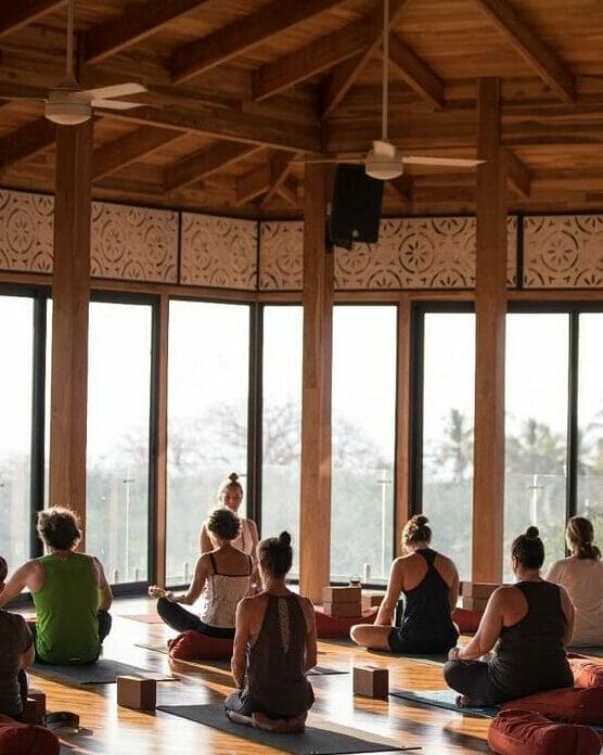 A diverse group of people practicing yoga poses in a quiet, serene studio.
